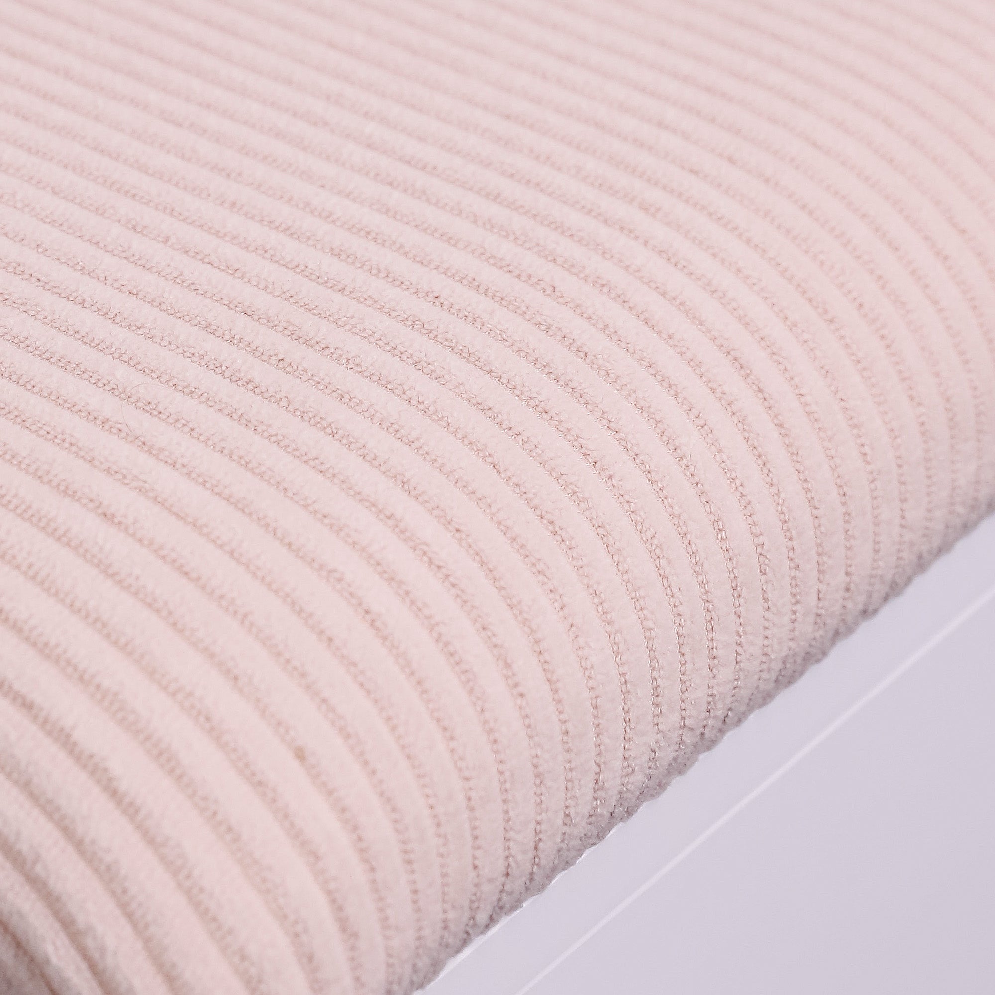 Close-up shot of the soft leather surface of the makeup stool.