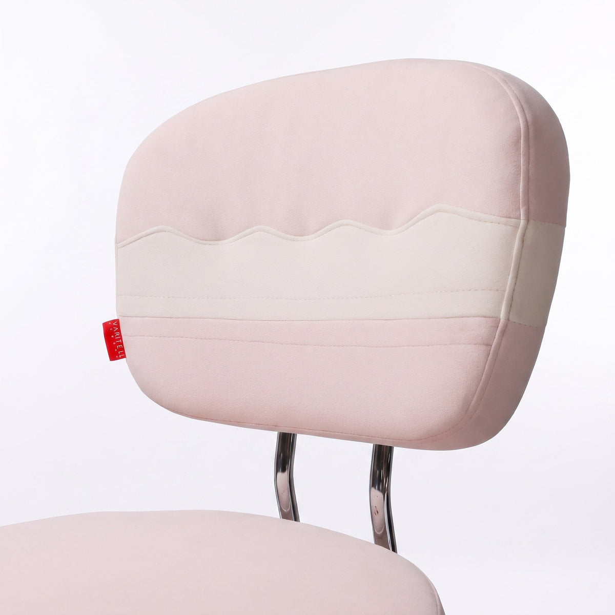 A close-up of a pink vanity chair backrest