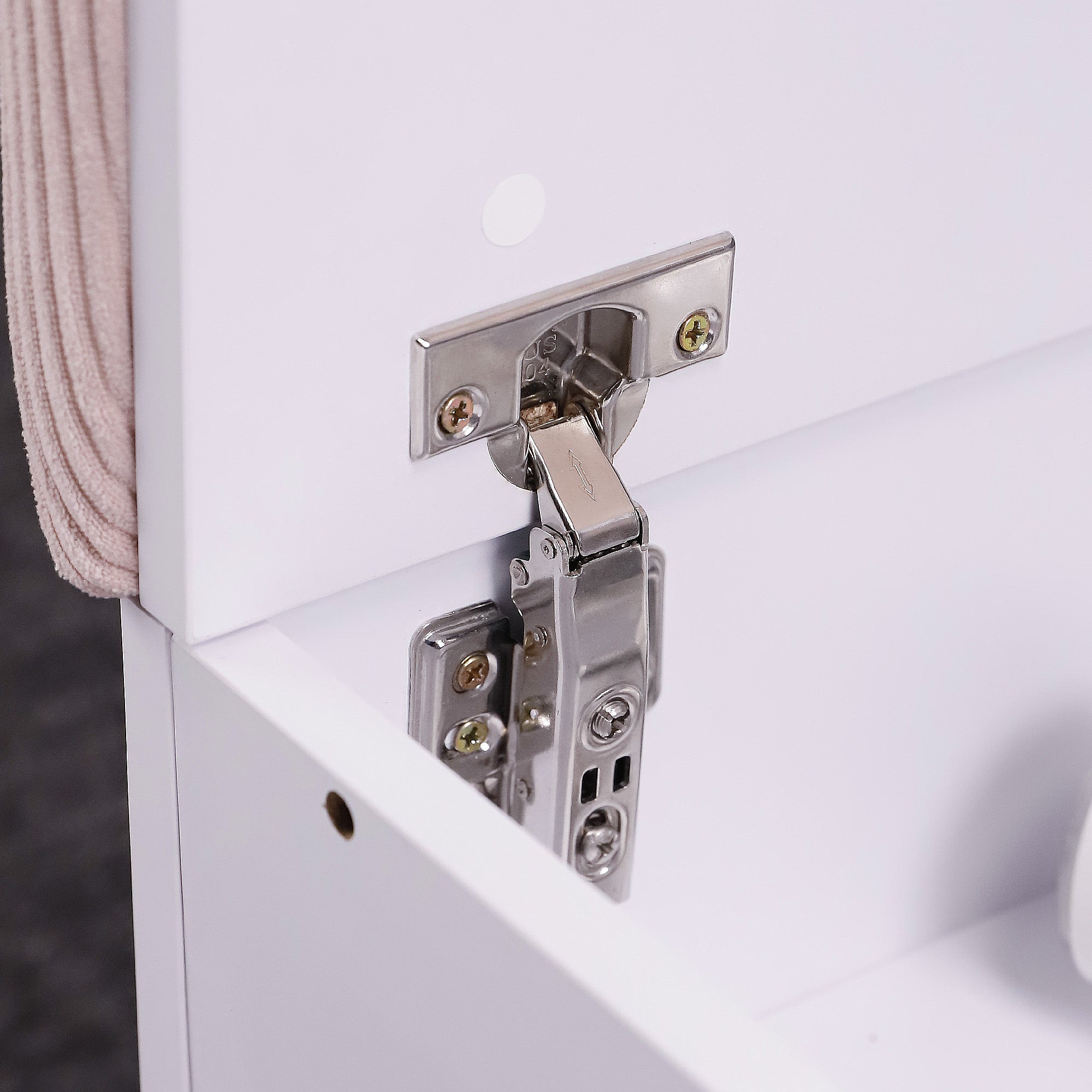 A close-up shot of the metal hinge of vanity stool.